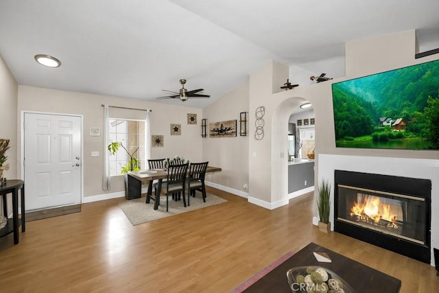 37206 Calle Mazatlan, Palmdale, CA 93552 - dining space with arched walkways, ceiling fan, vaulted ceiling, and wood finished floors