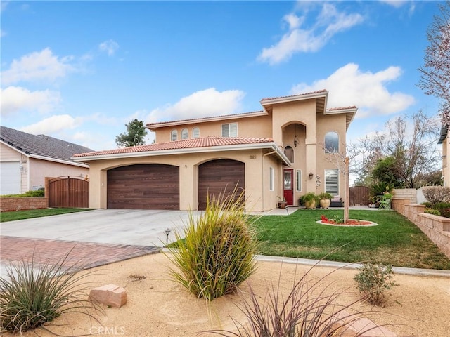 mediterranean / spanish-style house featuring driveway, fence, a front yard, and a gate