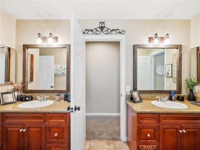 bathroom with tile patterned flooring, two vanities, and a sink