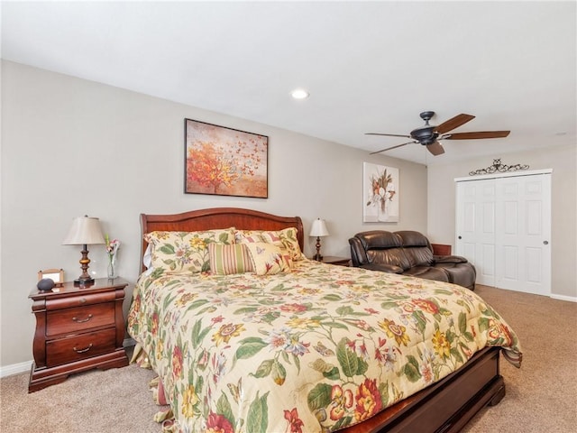 bedroom featuring a ceiling fan, carpet, baseboards, and a closet