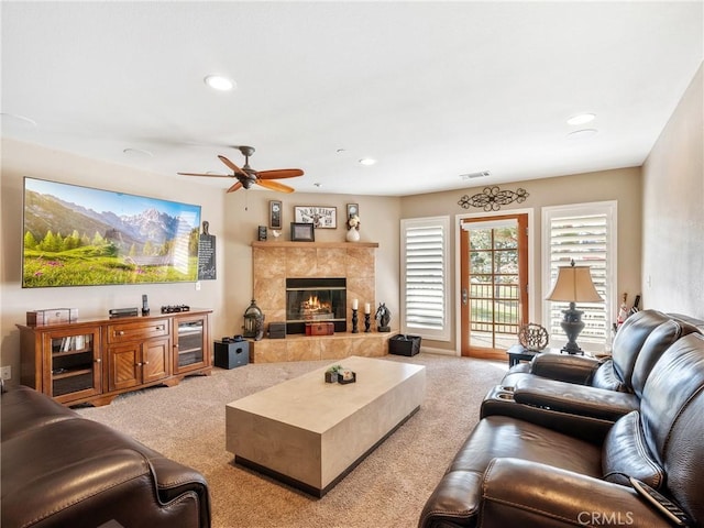 living room featuring visible vents, recessed lighting, a fireplace, ceiling fan, and light carpet