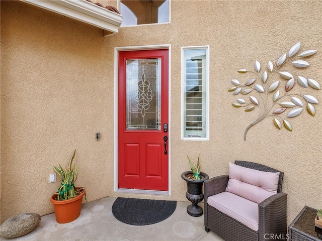 doorway to property with stucco siding