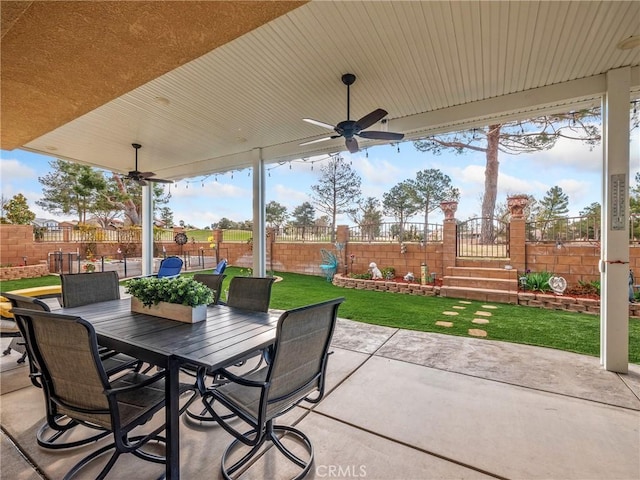 view of patio with outdoor dining area, a fenced backyard, and ceiling fan