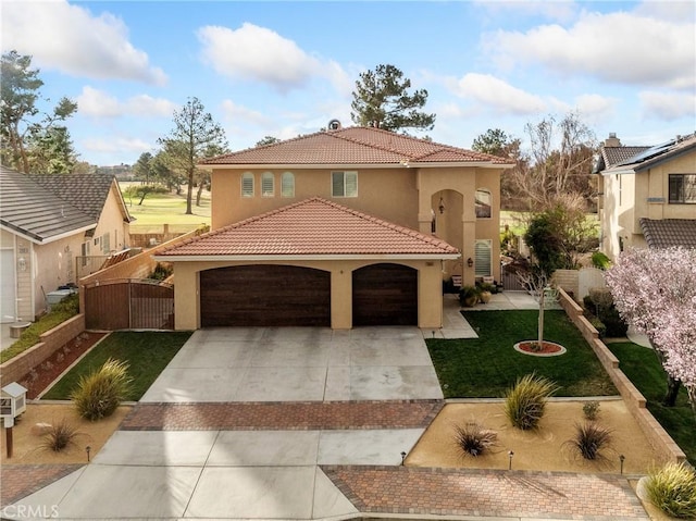 mediterranean / spanish-style house featuring a front lawn, driveway, fence, a garage, and a tiled roof