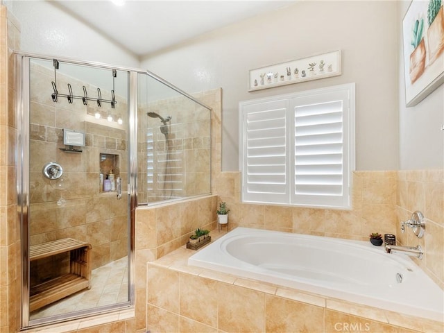 bathroom featuring a stall shower and a garden tub