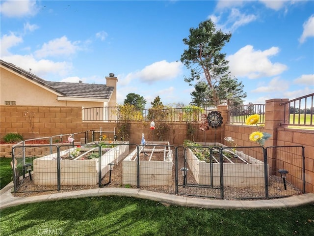 view of yard featuring a vegetable garden and fence