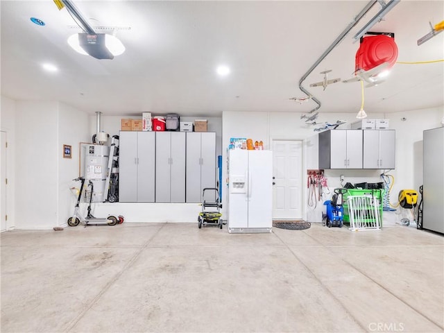 garage with a garage door opener and white fridge with ice dispenser