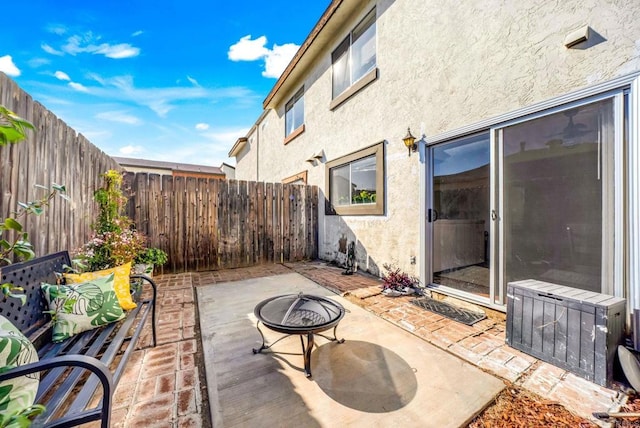 view of patio with a fenced backyard and an outdoor fire pit