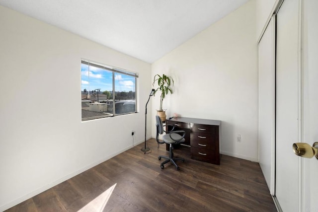 home office featuring dark wood-style floors, baseboards, and lofted ceiling