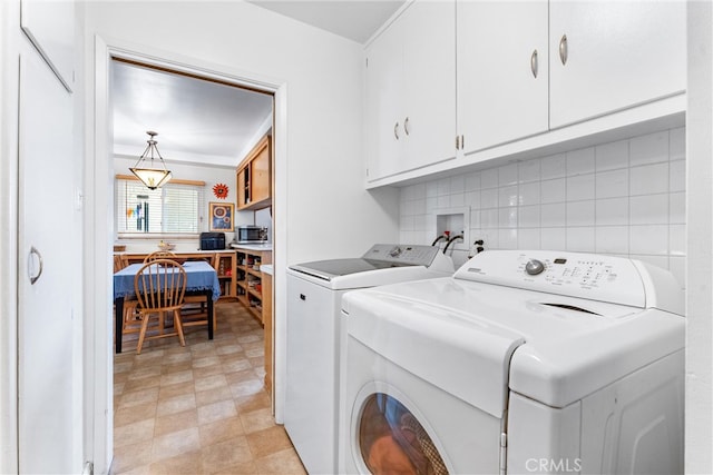 laundry room featuring cabinet space and washer and clothes dryer