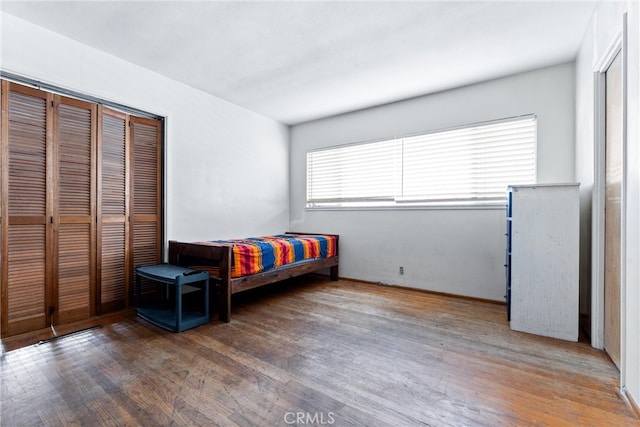 bedroom featuring wood finished floors and a closet