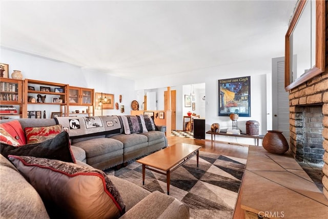 living area with a fireplace and wood finished floors