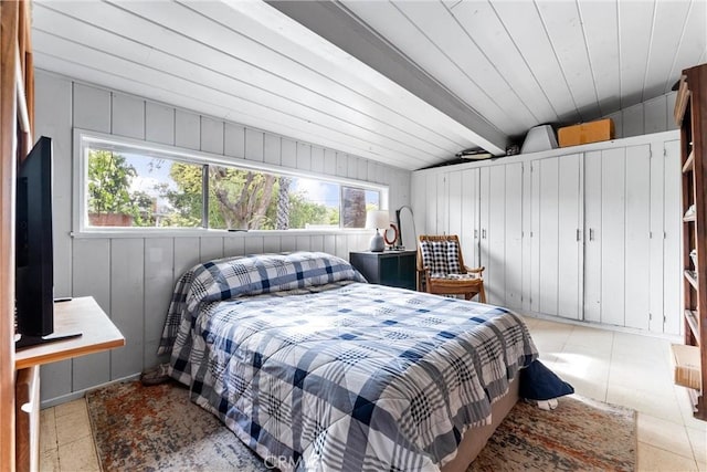 bedroom featuring tile patterned flooring, lofted ceiling with beams, multiple windows, and wooden ceiling