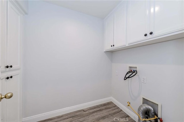 laundry room featuring wood finished floors, baseboards, cabinet space, washer hookup, and hookup for a gas dryer