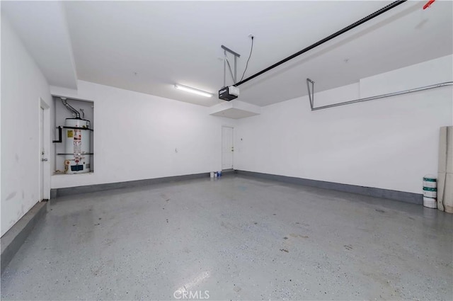 garage featuring secured water heater, a garage door opener, and baseboards