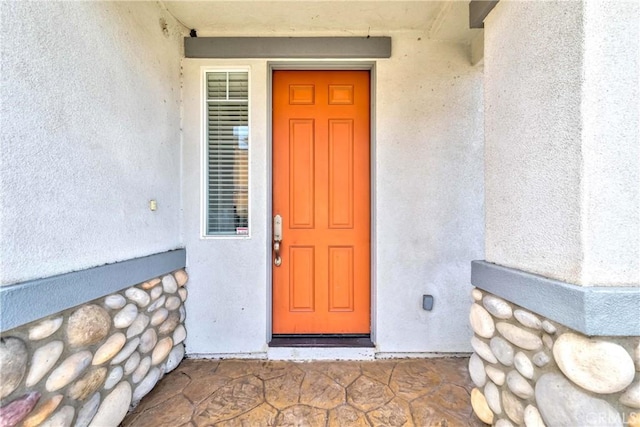 property entrance featuring stucco siding