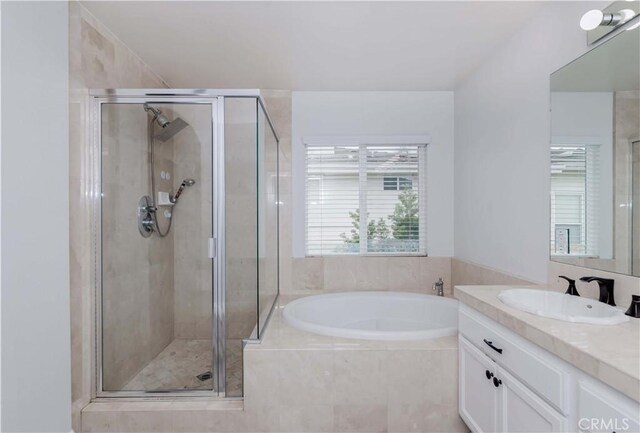 bathroom featuring vanity, a shower stall, and a bath