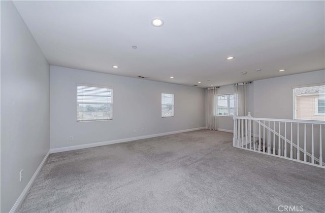 unfurnished room with carpet flooring, recessed lighting, and baseboards