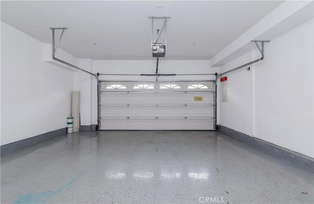 garage featuring a garage door opener and baseboards