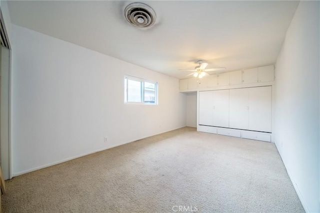 unfurnished bedroom featuring a ceiling fan, visible vents, a closet, and light carpet