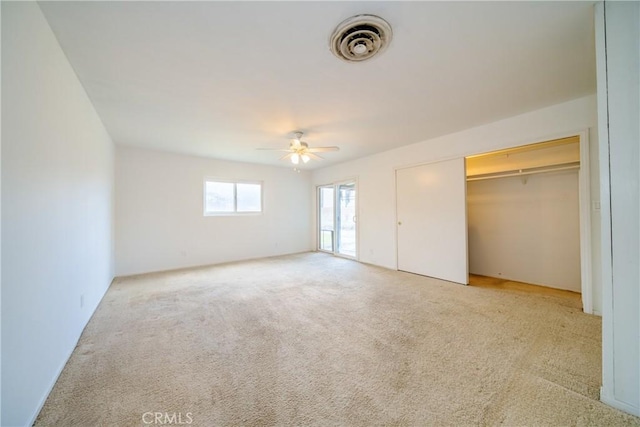 unfurnished bedroom featuring carpet flooring, visible vents, and ceiling fan