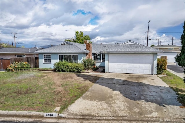 ranch-style home featuring stucco siding, driveway, fence, a front yard, and a garage