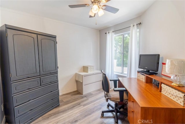 home office featuring light wood-type flooring and a ceiling fan