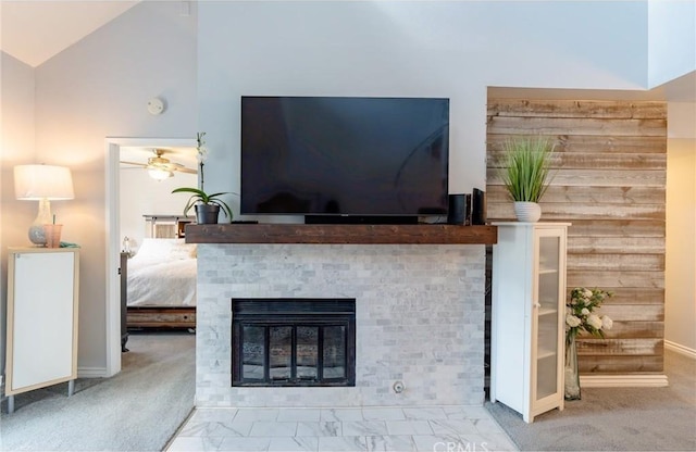 details featuring a glass covered fireplace, carpet flooring, and a ceiling fan