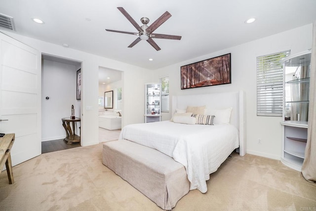 carpeted bedroom with visible vents, a ceiling fan, ensuite bathroom, recessed lighting, and baseboards