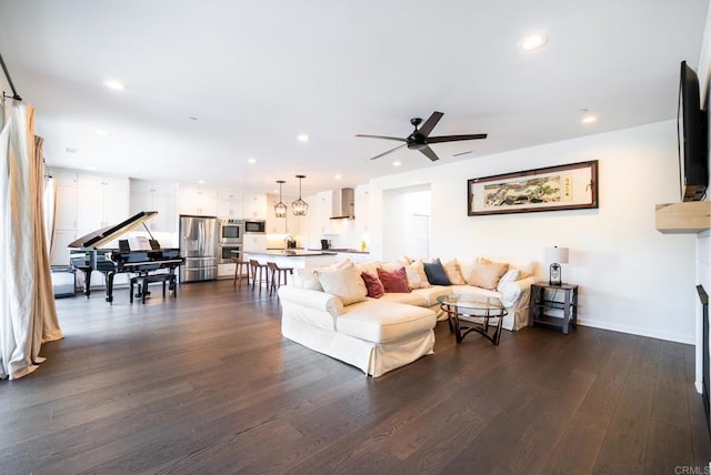 living area with recessed lighting, baseboards, a ceiling fan, and dark wood-style flooring