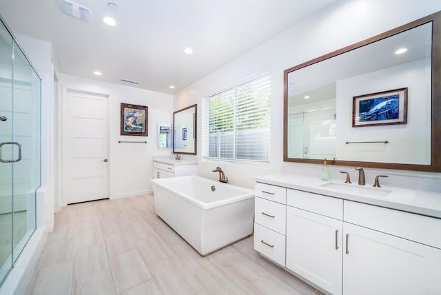 full bath featuring a sink, two vanities, recessed lighting, and a shower stall