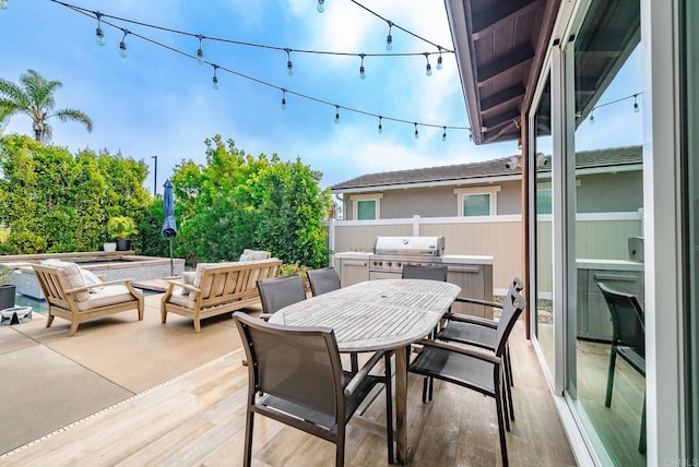 view of patio / terrace featuring outdoor dining area, fence, and a grill