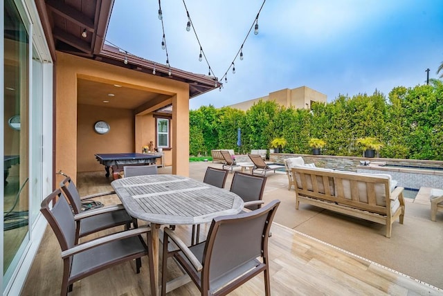 view of patio / terrace with an in ground hot tub and outdoor dining space