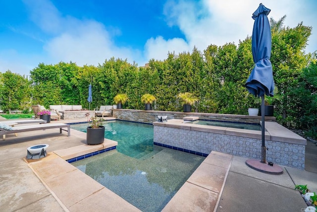 pool featuring an in ground hot tub, a patio area, and an outdoor living space