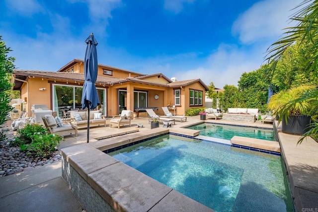 back of property featuring outdoor lounge area, a patio area, a pool with connected hot tub, and stucco siding