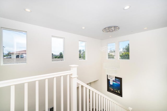 hallway featuring recessed lighting and an upstairs landing