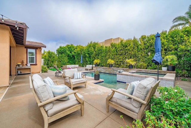 view of patio / terrace featuring outdoor lounge area, an in ground hot tub, and an outdoor pool