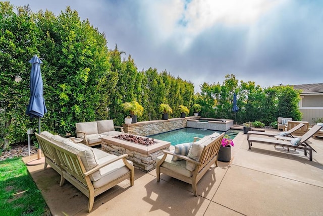 view of pool featuring an in ground hot tub, a fire pit, and a patio