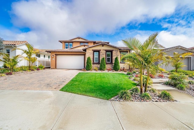 mediterranean / spanish-style home featuring a front lawn, fence, stucco siding, a garage, and driveway