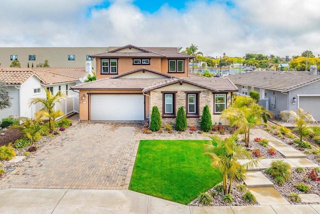 view of front of house featuring stucco siding, a front lawn, decorative driveway, stone siding, and fence