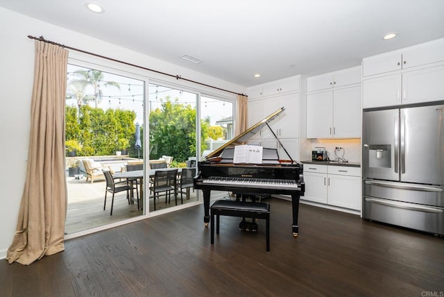 living area featuring visible vents, recessed lighting, and dark wood-style flooring