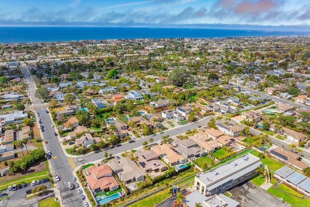 drone / aerial view featuring a residential view and a water view