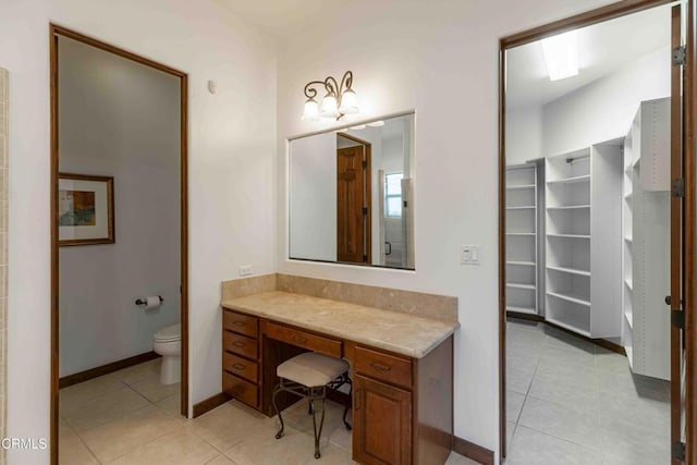 full bathroom with tile patterned flooring, toilet, vanity, and baseboards