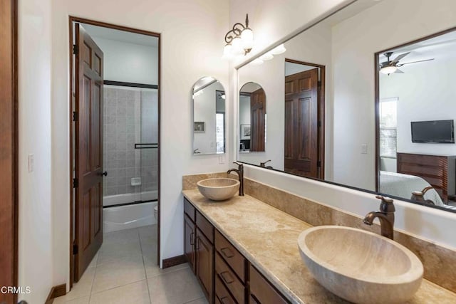 full bath featuring tile patterned flooring, double vanity, a ceiling fan, and a sink