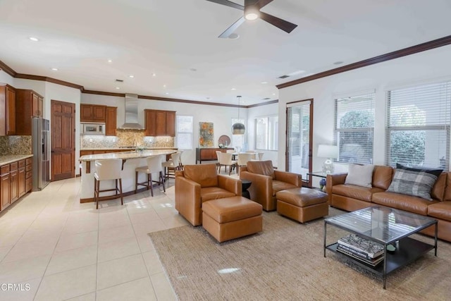 living room with light tile patterned floors, recessed lighting, a ceiling fan, and ornamental molding