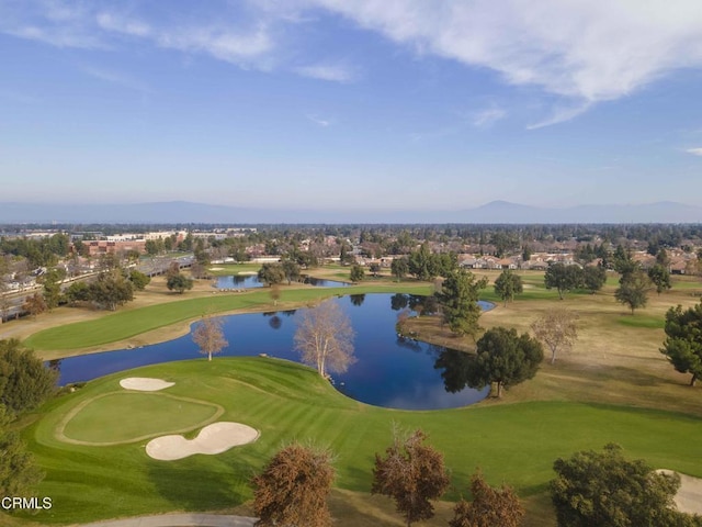 aerial view featuring view of golf course and a water and mountain view