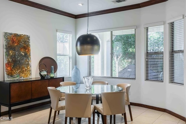 dining area featuring light tile patterned floors, visible vents, baseboards, and ornamental molding