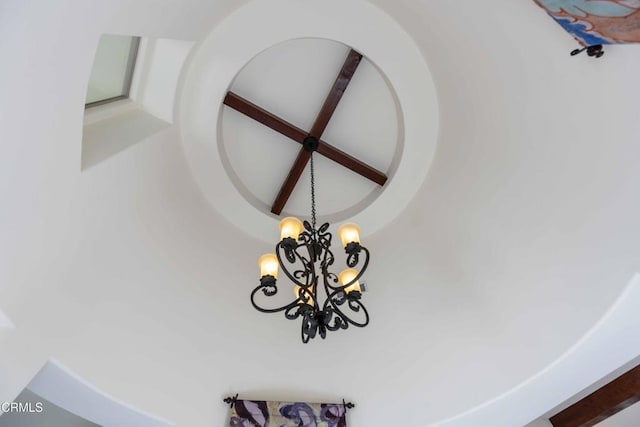 interior details featuring beam ceiling and an inviting chandelier