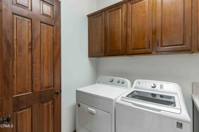 laundry room with washer and dryer and cabinet space