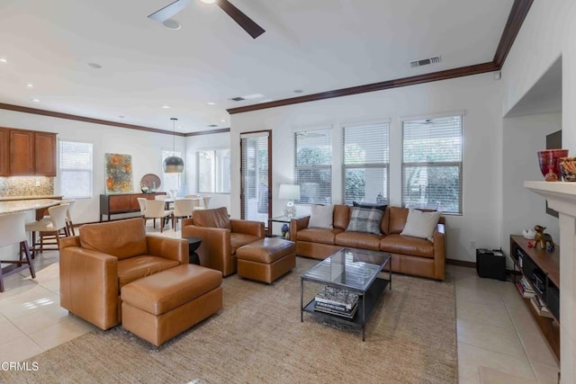 living area with baseboards, ornamental molding, light tile patterned floors, recessed lighting, and a ceiling fan